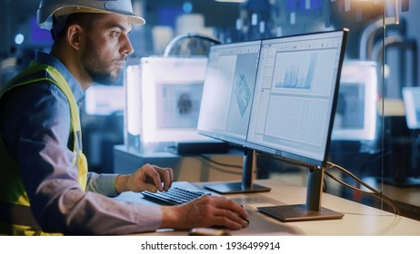 Electronics Design Factory Office: Portrait of Handsome Male Engineer Wearing Safety Vest Working on Computer, Developing Industrial Microchips. Manufacturing Processors.