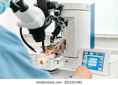 Electronics Engineering Scientist  Working With Microscope Looking At Silicon Micro Chip. Chemicals Researcher Investigating Micro Chip. Semiconductor Technological Manufacturing Process Control