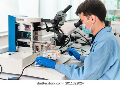 Electronics Engineering Scientist  Working With Microscope Looking At Silicon Micro Chip. Chemicals Researcher Investigating Micro Chip. Semiconductor Technological Manufacturing Process Control