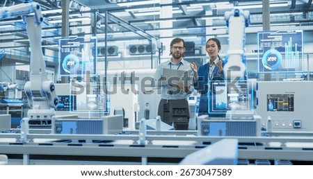 Electronics Factory Assembly Line Digitalization: Automated Robot Arms Manufacturing Advanced Equipment. Managers Discussing Work while Futuristic AI Computer Vision Analyzing, Scanning Conveyor Line