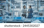 Electronics Factory Digitalization: Automated Robot Arm Assembly Line Manufacturing Equipment. Managers Discussing Work while Futuristic AI Computer Vision Analyzing, Scanning Production Line