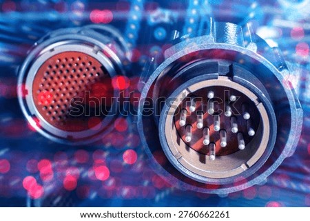 Electronics manufacturing, industrial engineering. Close-up of multi-pin circular connectors for power or data transmission, used in aerospace, automation, robotics, or telecommunications equipment.