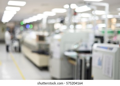 Electronics production plant creative abstract blur background with bokeh effect. Indoor photo of PCB assembly plant with SMT machine and workers.  - Shutterstock ID 575204164