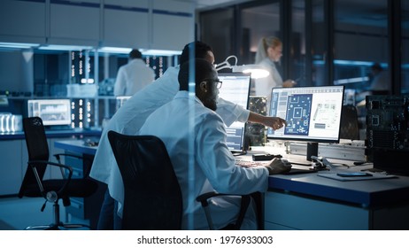 Electronics Research, Development Facility: Engineer Project Manager Talks With Scientist Working On Computer. Diverse Team Of Professionals Design Silicon Microchip, Semiconductors, Motherboard