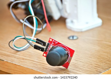 Electronics and robotics of handmade. Microcircuits and colored wires close up. Electronic devices and mechanisms are presented at the scientific exhibition. Joystick and control button.