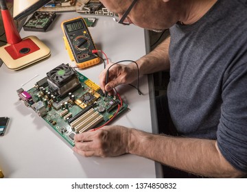 electronics technician is testing a computer chip. PC repair
