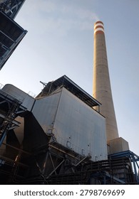 Electrostatic Precipitator (ESP) and industrial stack at a power plant facility, forming an essential part of the emission control system. The ESP is designed to capture and remove particulate matter from flue gases before they are released through the stack, helping improve air quality and support environmental compliance. These large industrial structures represent modern power generation infrastructure and pollution control technology