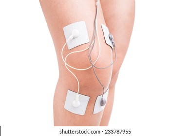 Electrostimulator massager on her knee. Injury athlete.