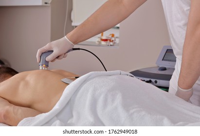 Electrotherapy and ultrasound therapy, Back pain relief . Sport injury rehabilitation for male patient - Powered by Shutterstock