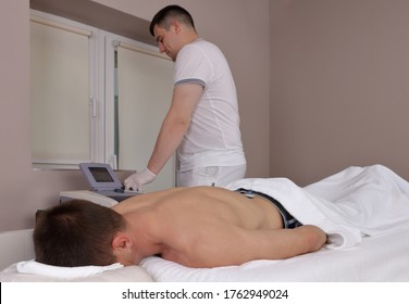 Electrotherapy and ultrasound therapy, Back pain relief . Sport injury rehabilitation for male patient - Powered by Shutterstock