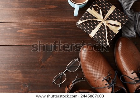 Elegance from above: A Father's Day array of polished shoes and gifts, laid out on classic wood with room for your festive words