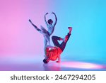 Elegance and Energy. Ballerina and breakdancer, young girl and boy preforming classical and contemporary dance in neon light. Concept of classical and modern dance, performance, hobby, talent show