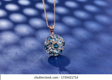 Elegance Gold Pendant Necklace With Blue Topaz Gemstones On Blue Background. Fashion Jewelry With Natural Gemstone