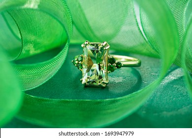 Elegance gold ring with beryl gem and emerald on bright green backround. Fashion gold jewelry with gemstone - Shutterstock ID 1693947979