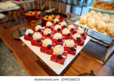 Elegance in Red: Bite-sized Red Velvet Cake Slices Ready to Tempt Palates at the Buffet Line - Powered by Shutterstock