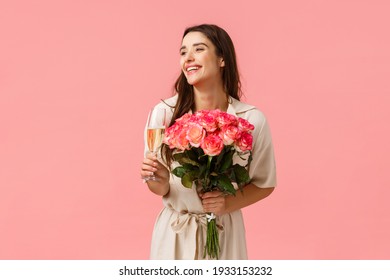 Elegance, romance and valentines day concept. Woman celebrating birthday, having fun, enjoying party, holding champagne glass, drinking and laughing, receiving beautiful bouquet flowers