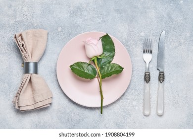 Elegance Table Setting With Pink Plate Decorated Rose Flowers On Grey Background. Elegance Holiday Dinner. Top View. Space For Text.