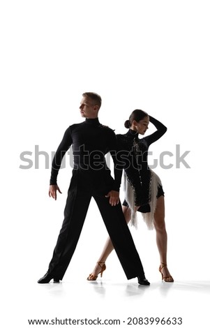 Elegance. Two young graceful dancers, flexible man and woman dancing ballroom dance isolated on white studio background. Concept of art, timeless, beauty, music, style. Copy space for ad