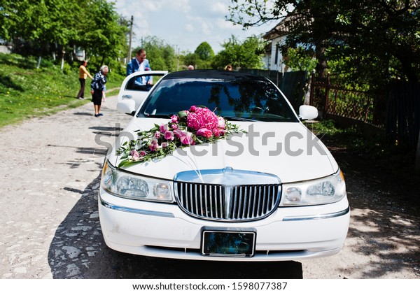 Elegance\
wedding limousine car with floral\
decoration.