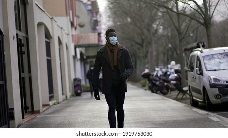 Elegant African Man Walking Outside Wearing Covid Surgical Face Mask