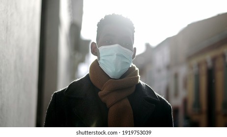 Elegant African Man Walking Outside Wearing Covid Surgical Face Mask