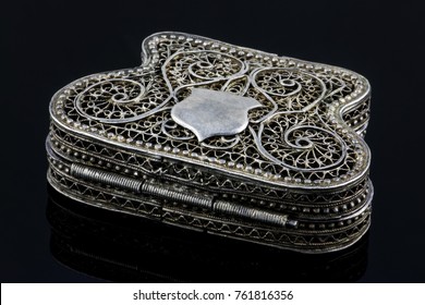 elegant antique small silver casket for jewelry isolated on black background with reflection. Work of an unknown jeweler 18th century, Armenia