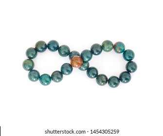 Elegant, beaded bracelet with lot of different colorful stones (blue, orange, green) that look similarly to planets, isolated on white background arranget as an ininity symbol.