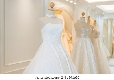 Elegant beautiful white wedding dress on a mannequin in a bridal boutique, luxury and romance, high-end bridal fashion, advertisements for bridal shops, excitement finding perfect dress for big day - Powered by Shutterstock