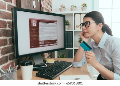 elegant beauty agent woman holding personal credit card thinking about whether using e-commerce system paying solving extort virus problem. - Shutterstock ID 659365801