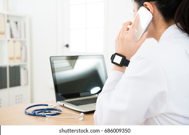 elegant beauty doctor woman wearing blank screen smartwatch working and using mobile phone talking with patient to solve sick problem. - Powered by Shutterstock