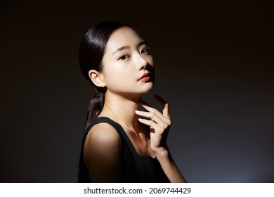 Elegant Beauty Portrait Of A Young Asian Woman In Light And Shadow