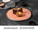 Elegant Beef Tartare with Egg Yolk and Toasts on Rustic Ceramic Plate.