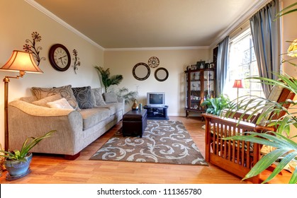 Elegant Beige Living Room With Blue And Old  Mall TV And Hardwood Floor.