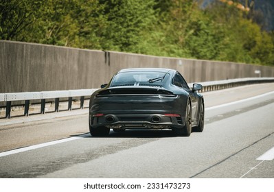 Elegant black modern two-door German roadster. Brand new black luxury carrera sports car on the highway. - Shutterstock ID 2331473273