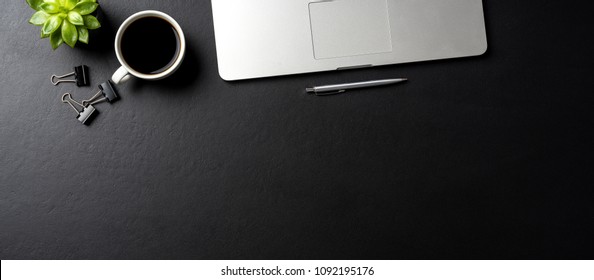 Elegant Black Office Desktop With Laptop And  Cup Of Coffee. Top View