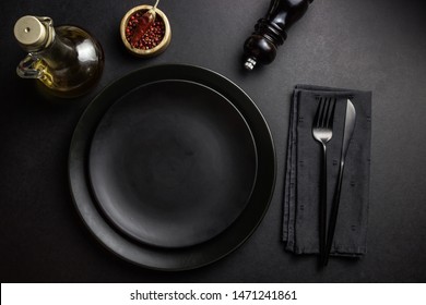 Elegant black table setting: plates, napkin and silverware over black background. Flat lay. copy space - Shutterstock ID 1471241861