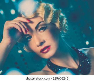 Elegant blond retro woman with beautiful hairdo and red lipstick