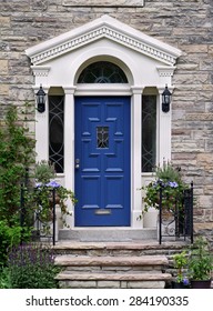 Elegant Blue Front Door On Stone House With Flagstone Steps