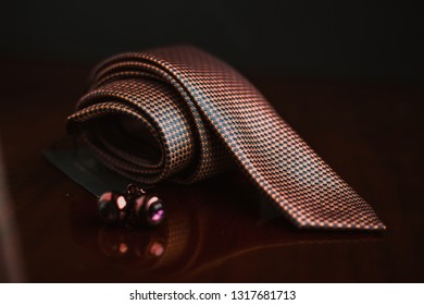 Elegant Blue And Red Necktie And Cufflinks ,pocket Square In Brown Background 