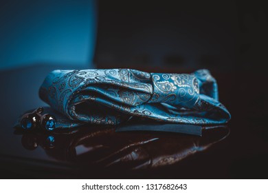 Elegant Blue And Red Necktie And Cufflinks ,pocket Square In Brown Background 