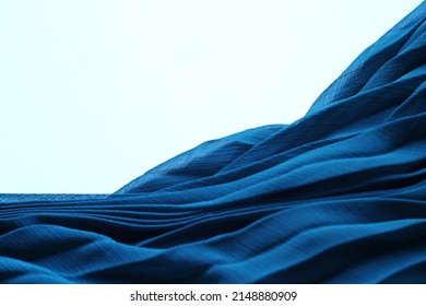 Elegant blue silk fabric. Aesthetic aquamarine tissue texture, folded dress textile. Azure ocean, luxurious pleated chiffon clothing on white background, 3d abstract sea waves