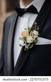 elegant boutonniere of white roses and eucalyptus leaves
