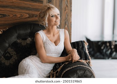 Elegant bride in a beautiful white dress sitting on a stylish sofa in a luxurious interior, smiling and looking happy. - Powered by Shutterstock