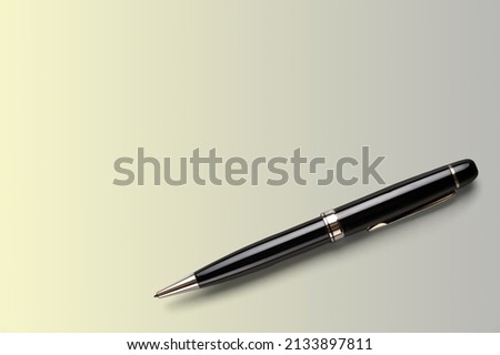 Elegant business black and gold ballpoint pen on the desk