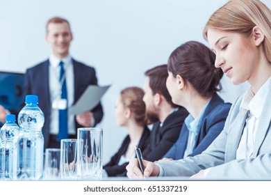 Elegant business lawyers writing during company board meeting