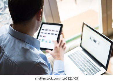 elegant business multitasking multimedia man using devices at home - Powered by Shutterstock