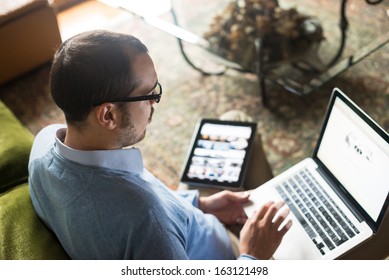 Elegant Business Multitasking Multimedia Man Using Devices At Home