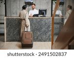 Elegant Business Woman with Travel Trolley Luggage in Hotel Lobby.