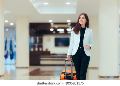 Elegant Business Woman With Travel Trolley Luggage In Hotel Lobby. Female Executive With Suitcase In Work Related Business Trip 
