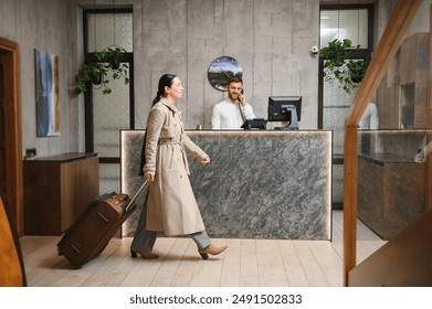 Elegant Business Woman with Travel Trolley Luggage in Hotel Lobby. - Powered by Shutterstock